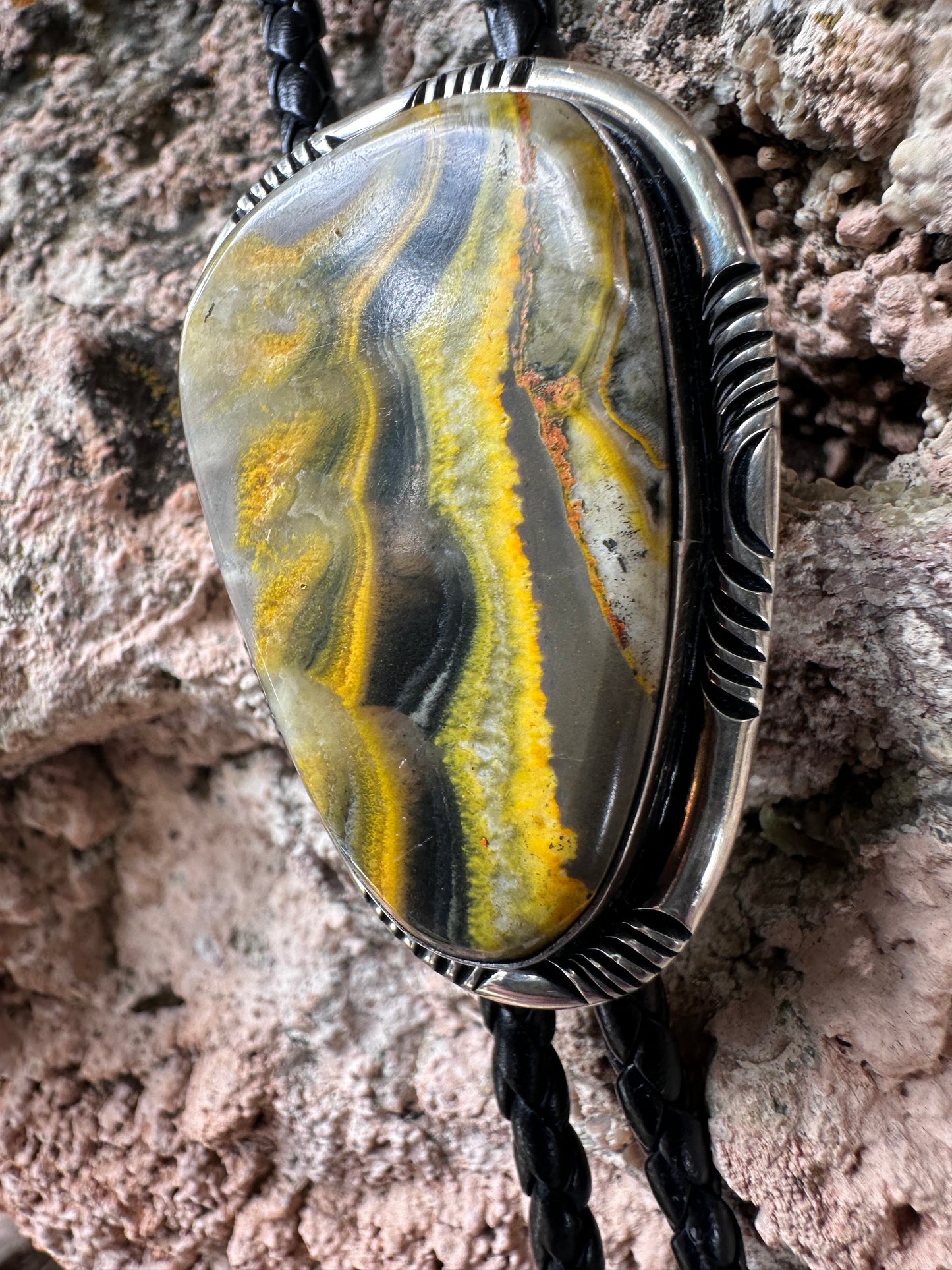 Jewelry with a stone pendant on a textured surface
